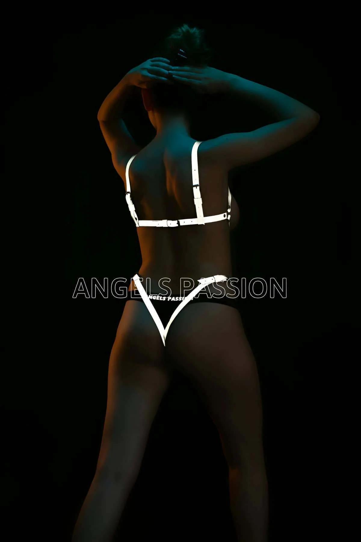 Side angle of white reflective body harness with adjustable buckle detail on shoulder strap