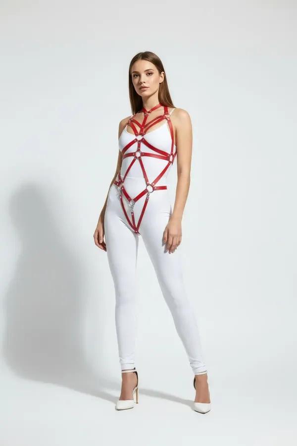 Red faux leather full body harness with three silver interlocking O-rings spanning chest to thigh worn over white bodysuit