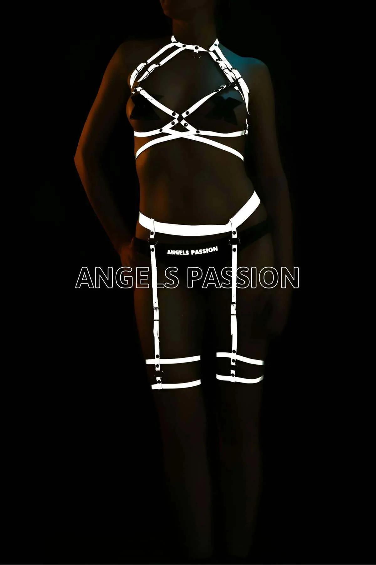 Close-up of silver-reflective holographic snap-buckle hardware on black elastic chest harness straps