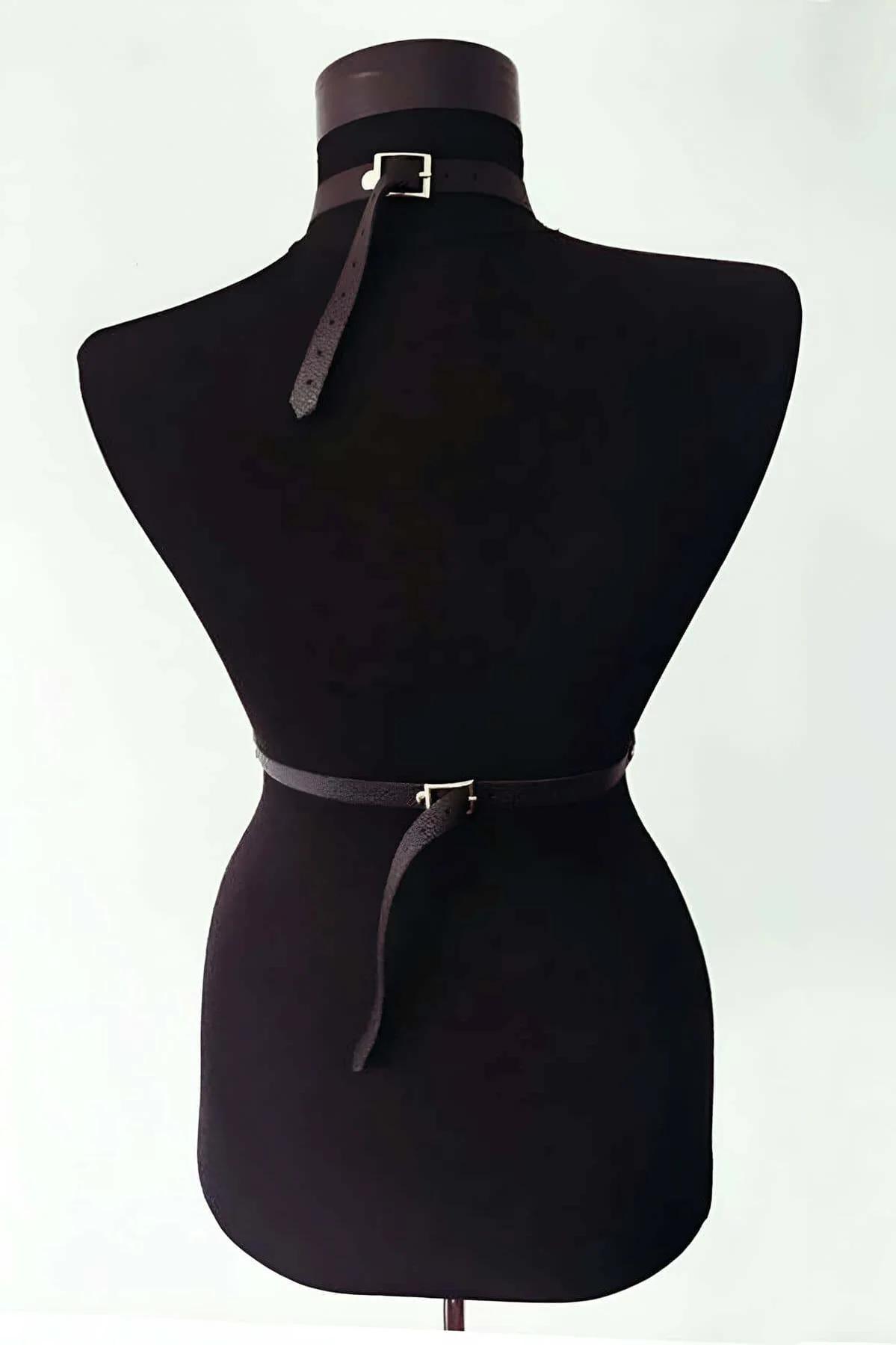 Black faux leather harness showing adjustable collar band and single diagonal chest strap from front angle