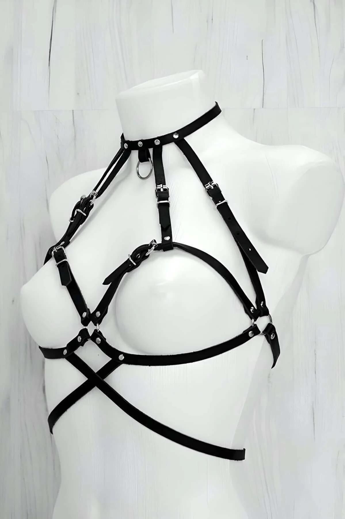 Front view of black PU leather chest harness showing triangular bra-cage strap frame and silver slider buckles