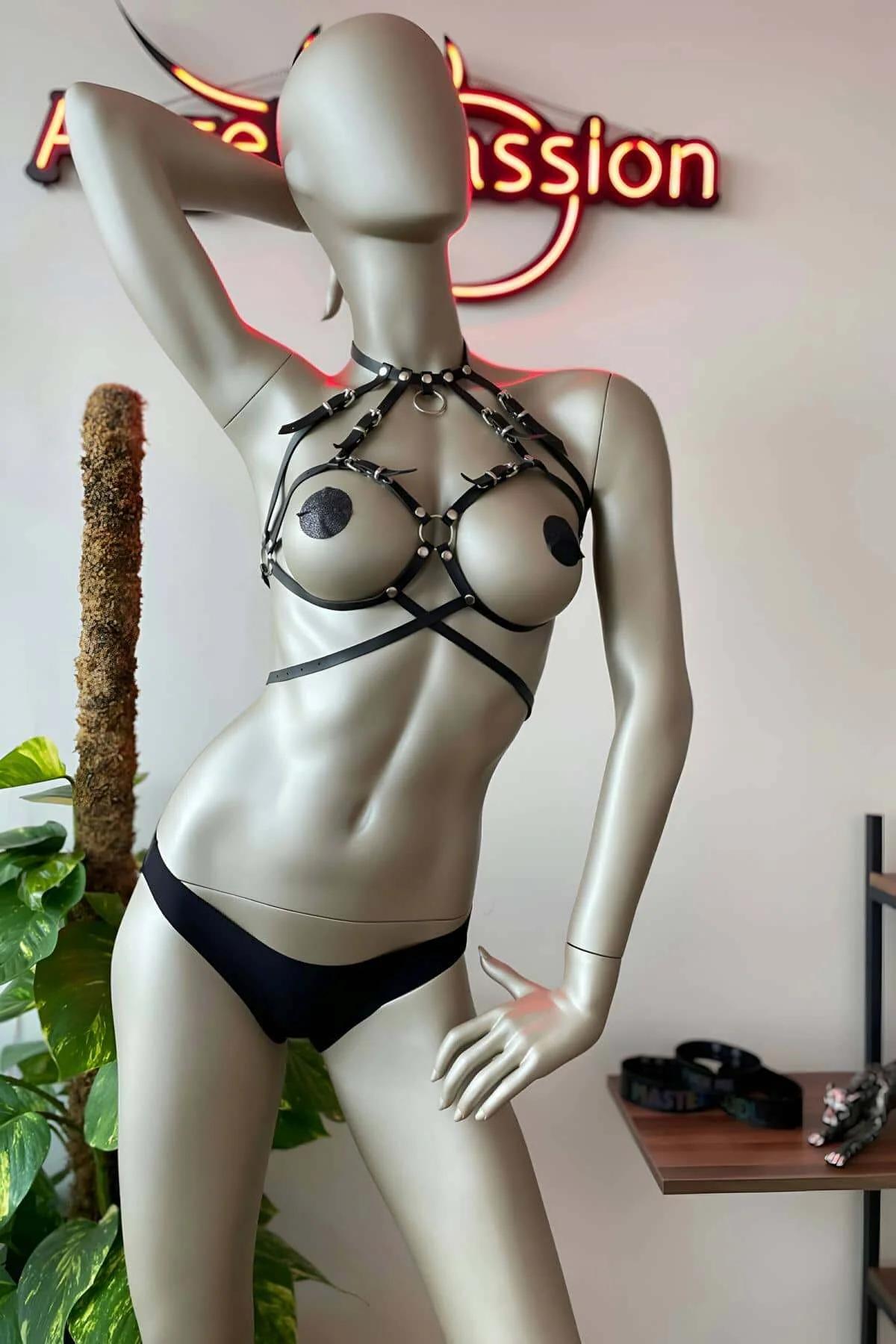 Black strappy chest harness adjustable buckle and shoulder strap configuration detail