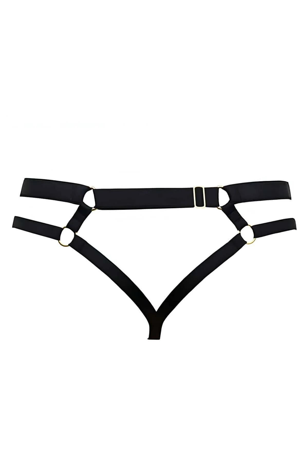 Close-up of gold O-ring hardware on black elastic thong harness showing strap width detail