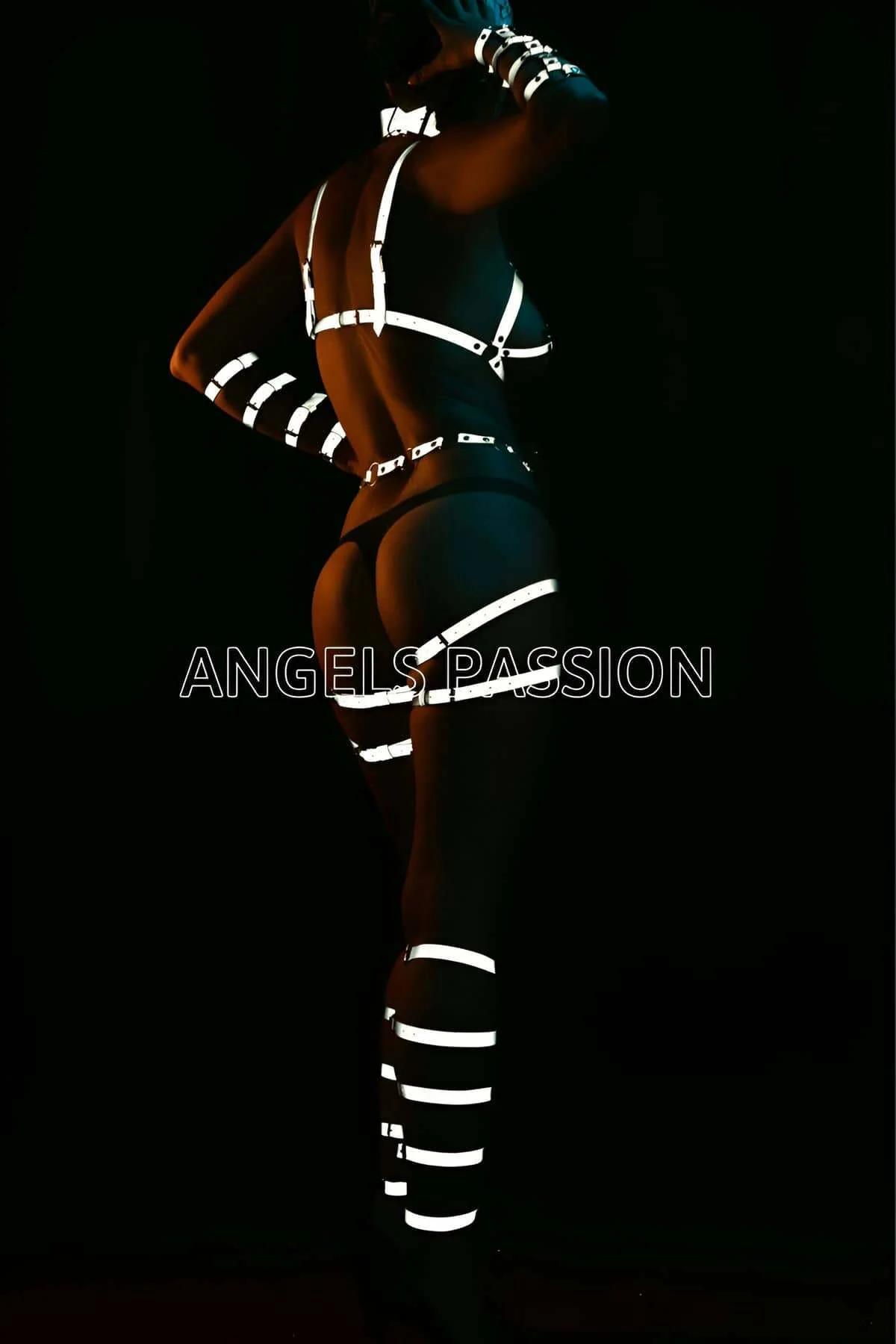 Side view of reflective white waist and hip strap harness with silver slide buckles