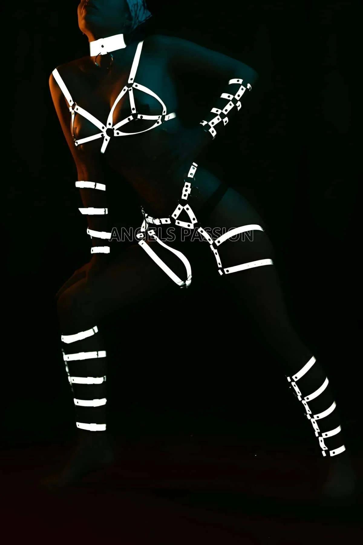 White reflective thigh cuffs with five stacked adjustable bands worn on both legs