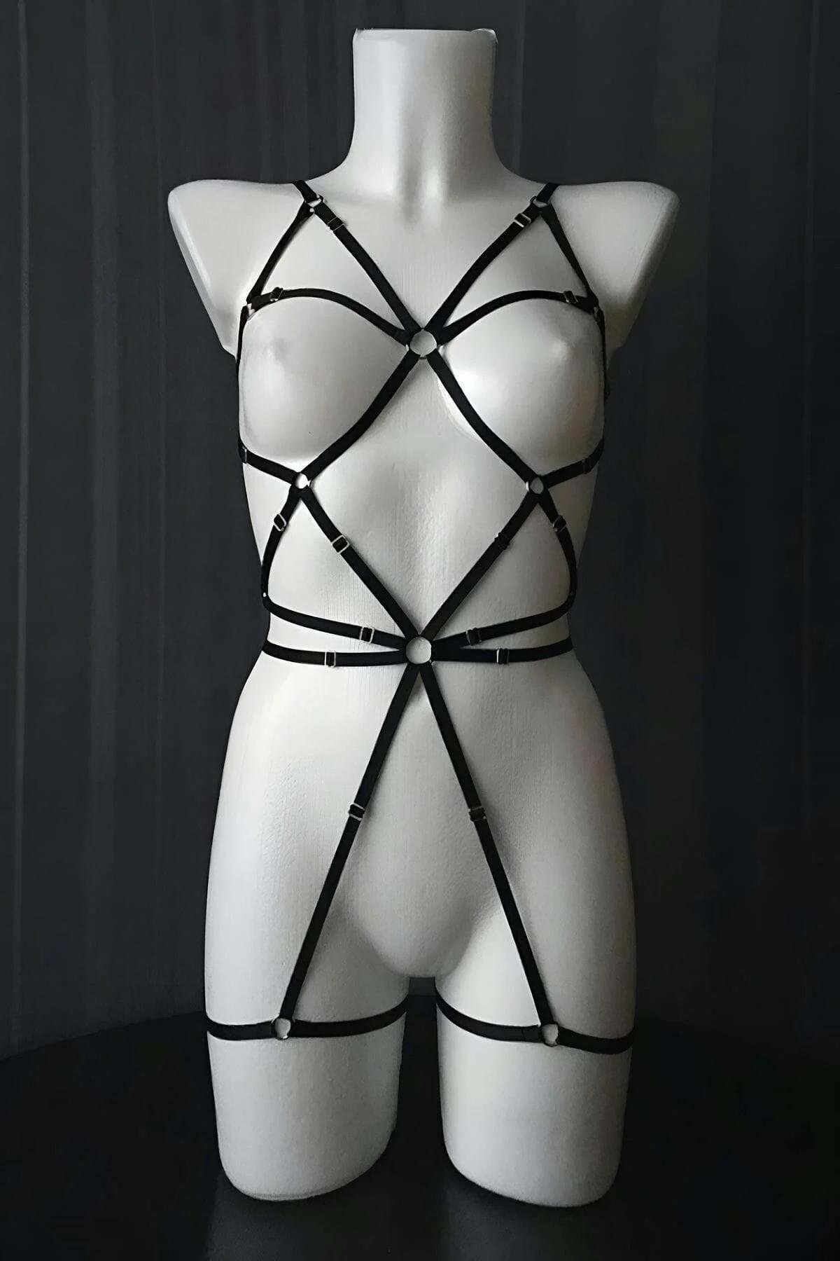 front view black sheer mesh bodysuit showing large polka dot print and crisscross torso strap detail