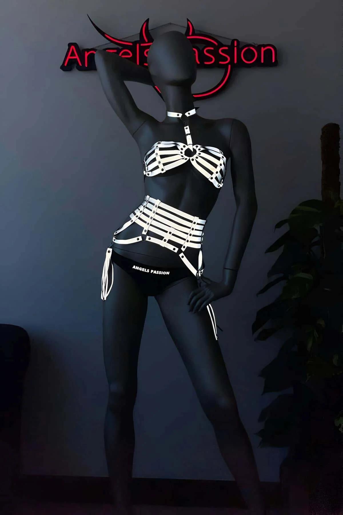 Full body view of white reflective harness set worn over dark background, UV festival outfit