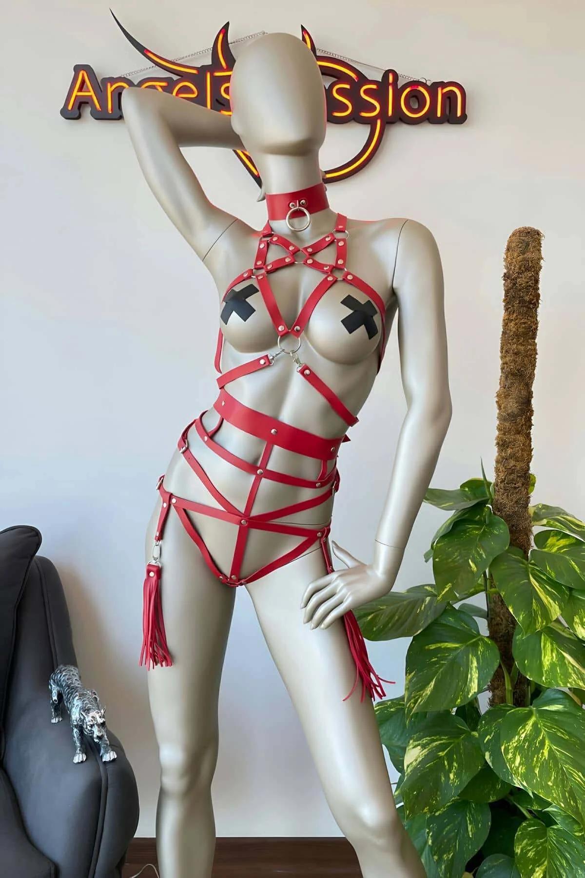 Close-up of red PU leather cage chest straps with silver dome studs and central O-ring connector