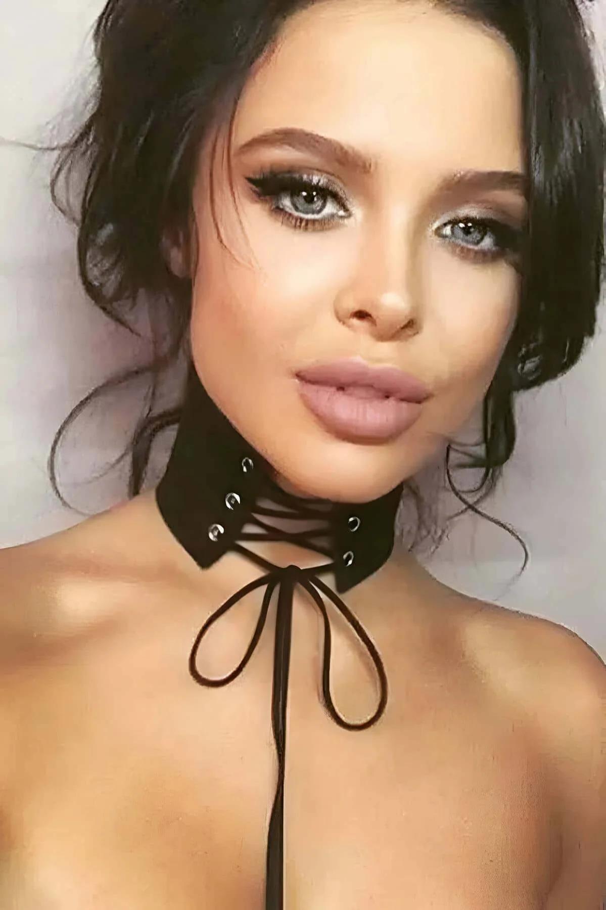 black faux suede lace-up choker with silver eyelets and long adjustable front tie straps worn at neck