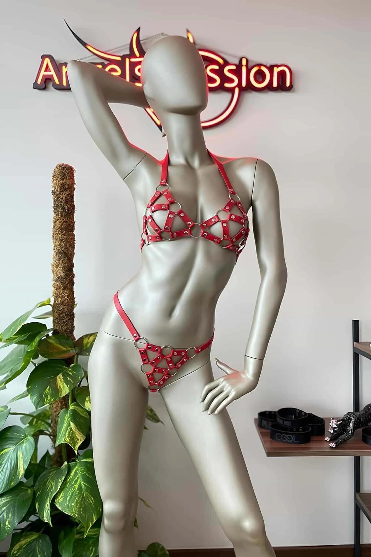 Close-up of red PU leather cage bra cups with silver O-rings and rivet detailing