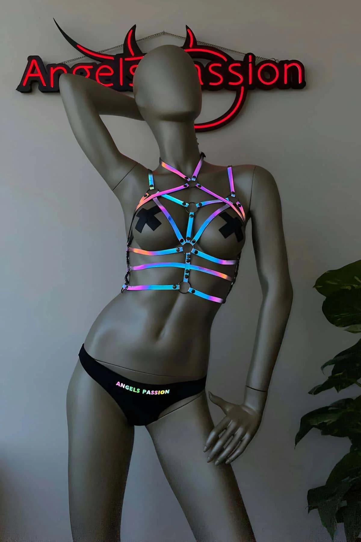Reflective body harness dark metal hardware rings at strap intersections UV glow