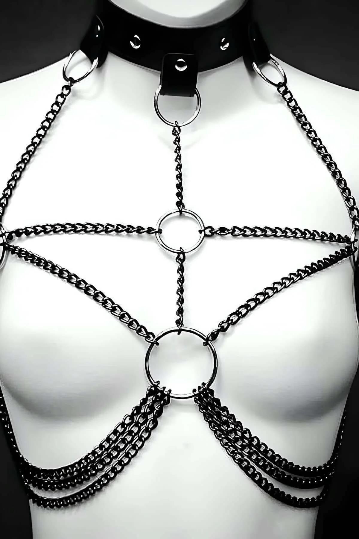 Close-up of gold-tone O-ring at center bust with parallel chain rows on either side