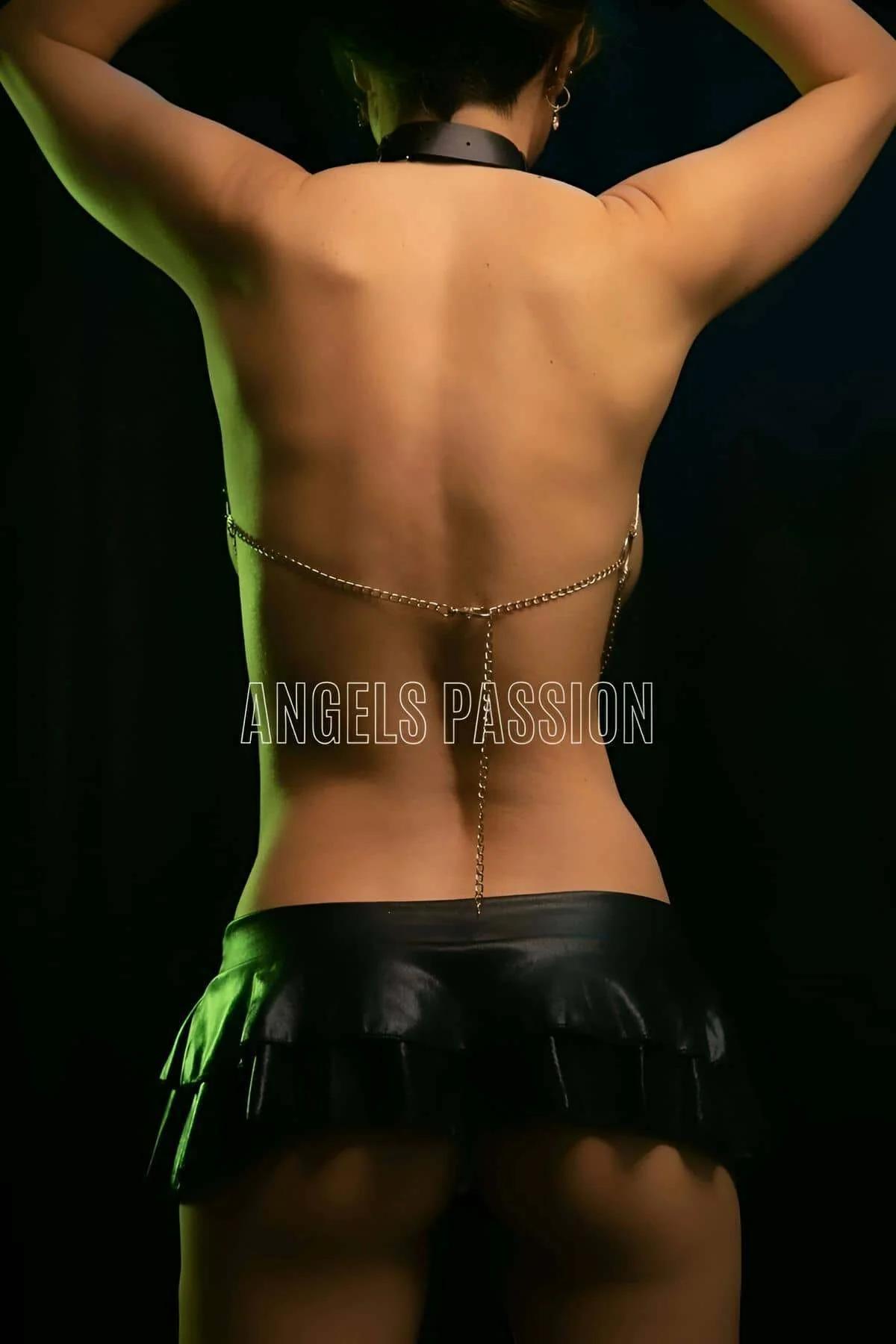 Black faux leather collar with silver lobster-clasp closure connected to gold chain harness
