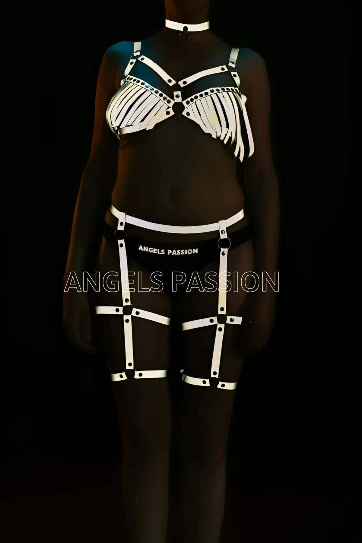 Close-up of reflective white fringe bra harness top with center O-ring and black rivets
