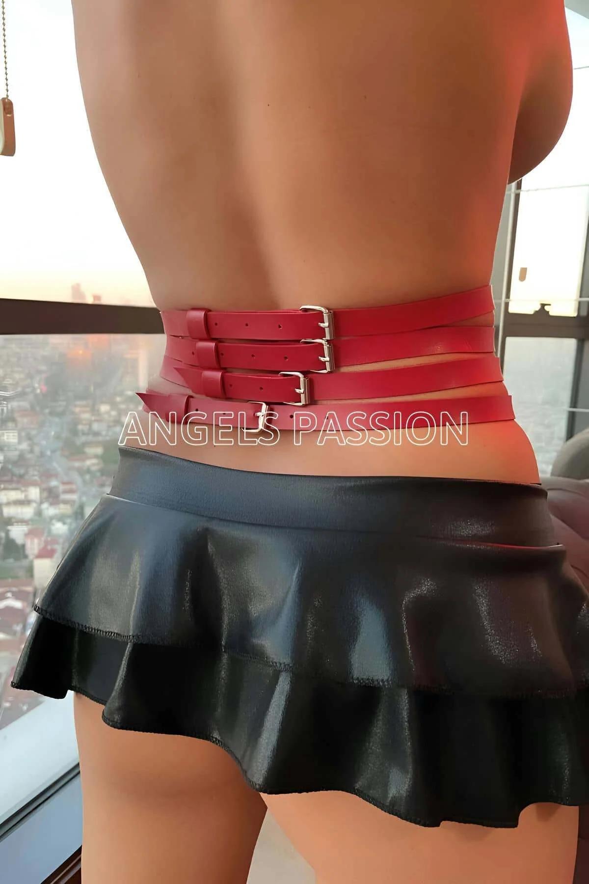 Close-up of gold-tone O-rings on red PU leather harness belt center front detail