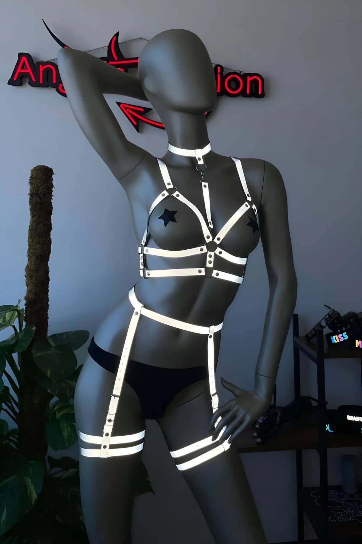 back view of reflective full body harness showing waist belt closure and drop strap garter connection