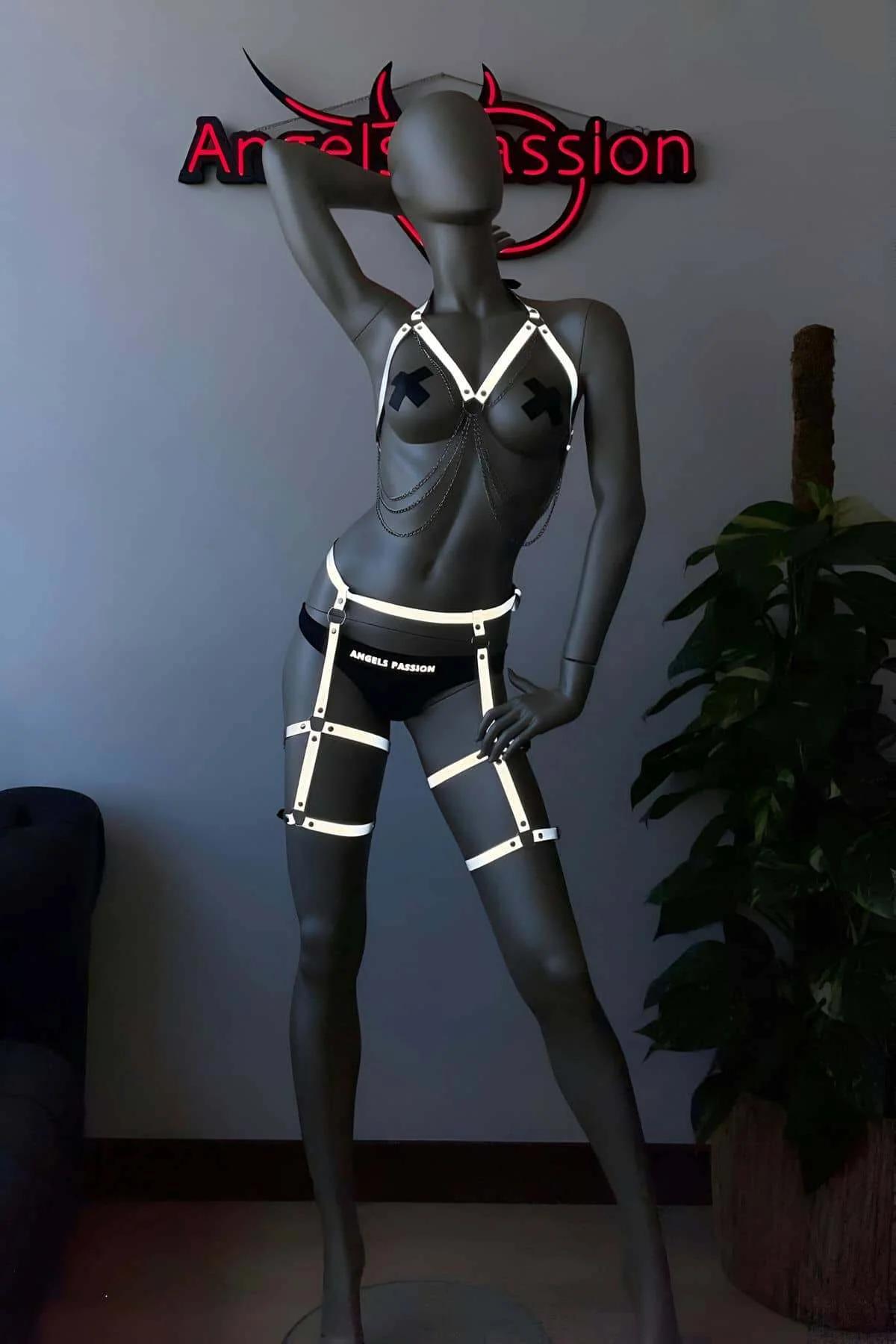 Full two-piece reflective harness set worn together showing chest and thigh pieces in neon-lit environment