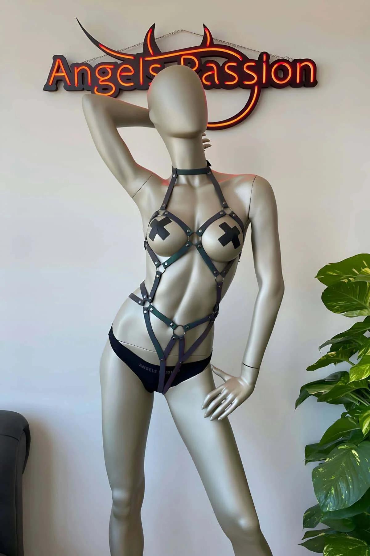 Iridescent reflective harness worn over bare skin showing vertical torso strap and hip band fit