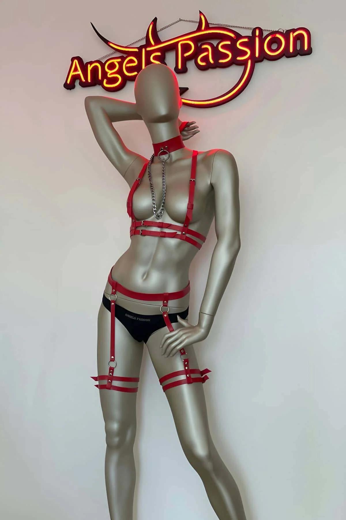 Red vegan leather double-strap thigh garters with silver O-ring adjusters on mannequin