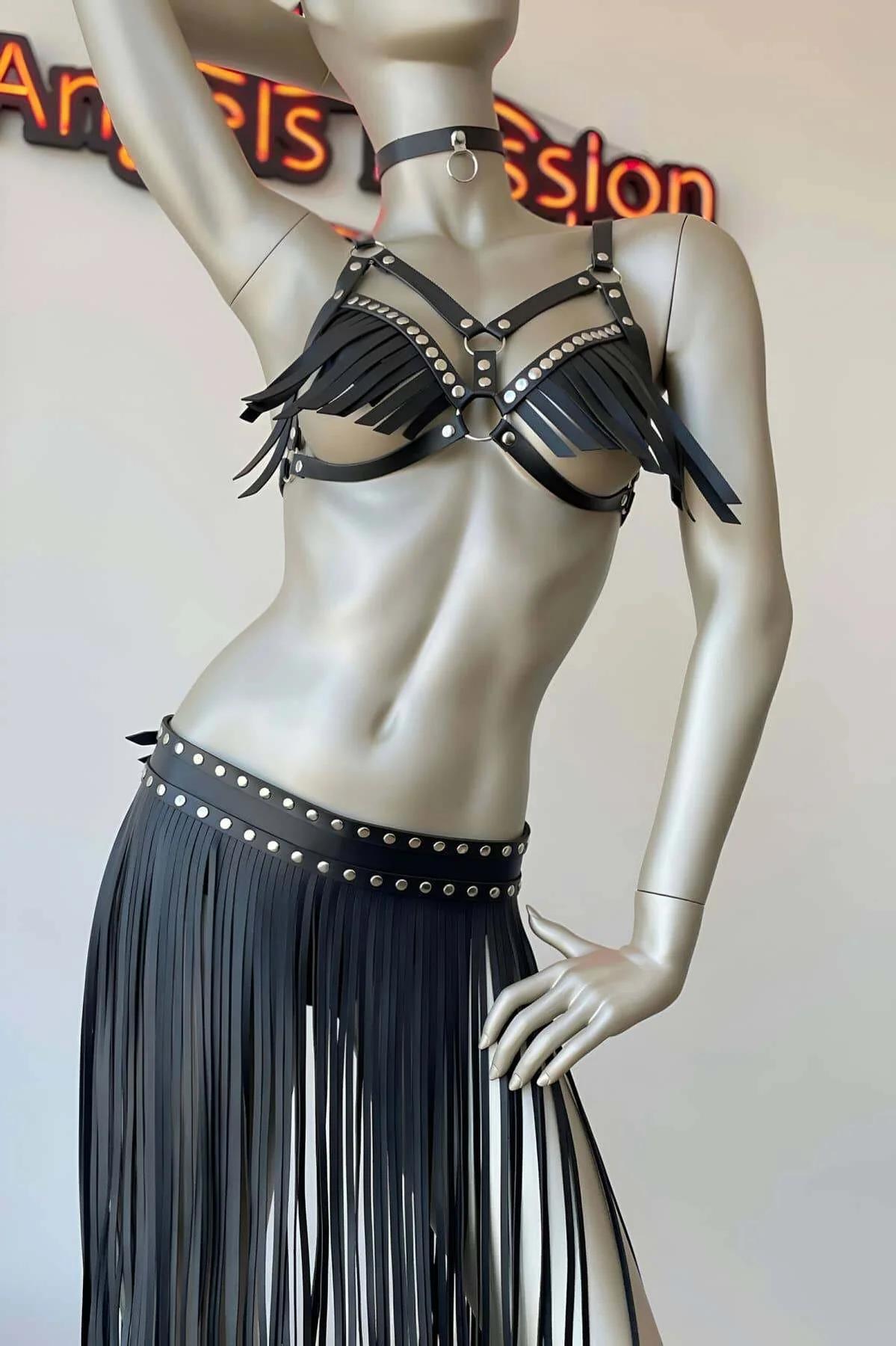Black studded waist skirt with wide faux leather band and long fringe panels, front view on mannequin