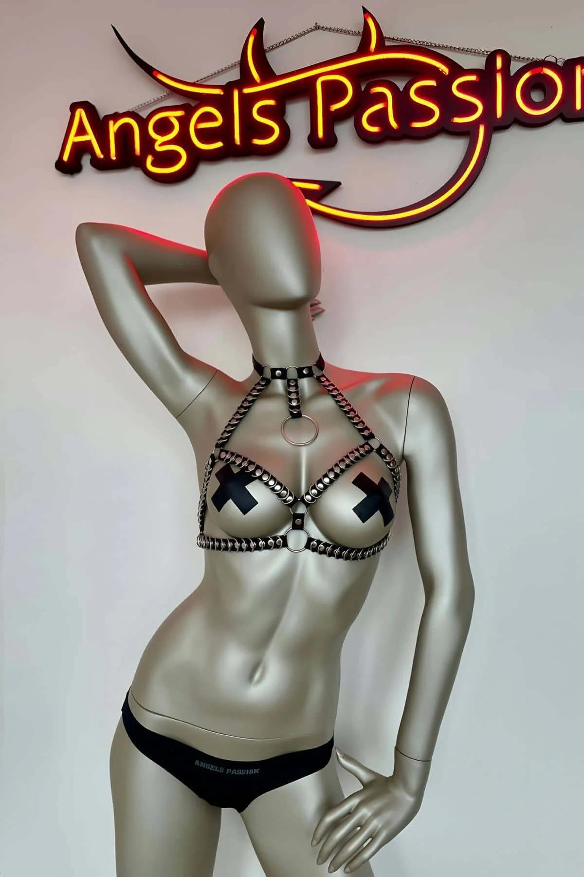 Full front view of black faux leather studded harness showing two-band chest layout and collar section