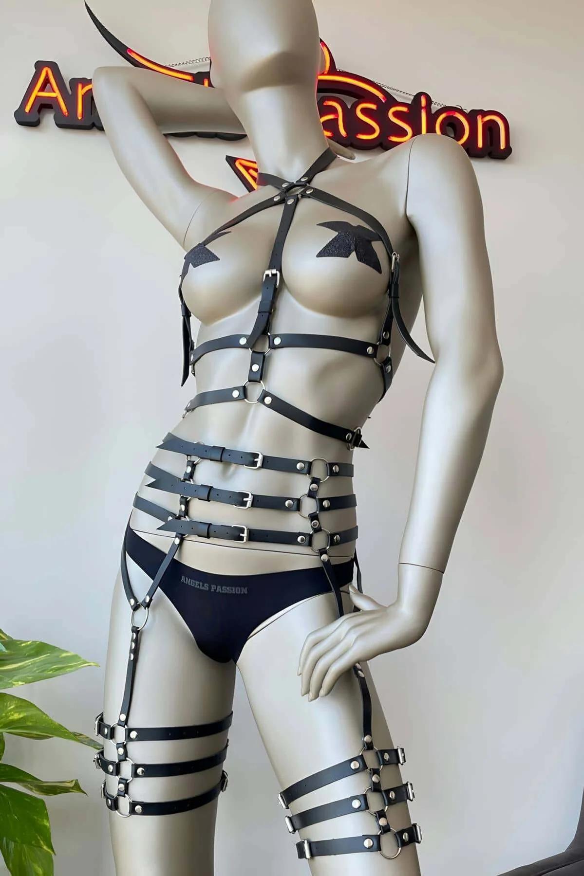 close-up of black faux leather waist cage harness with four stacked bands and silver flat-bar buckles