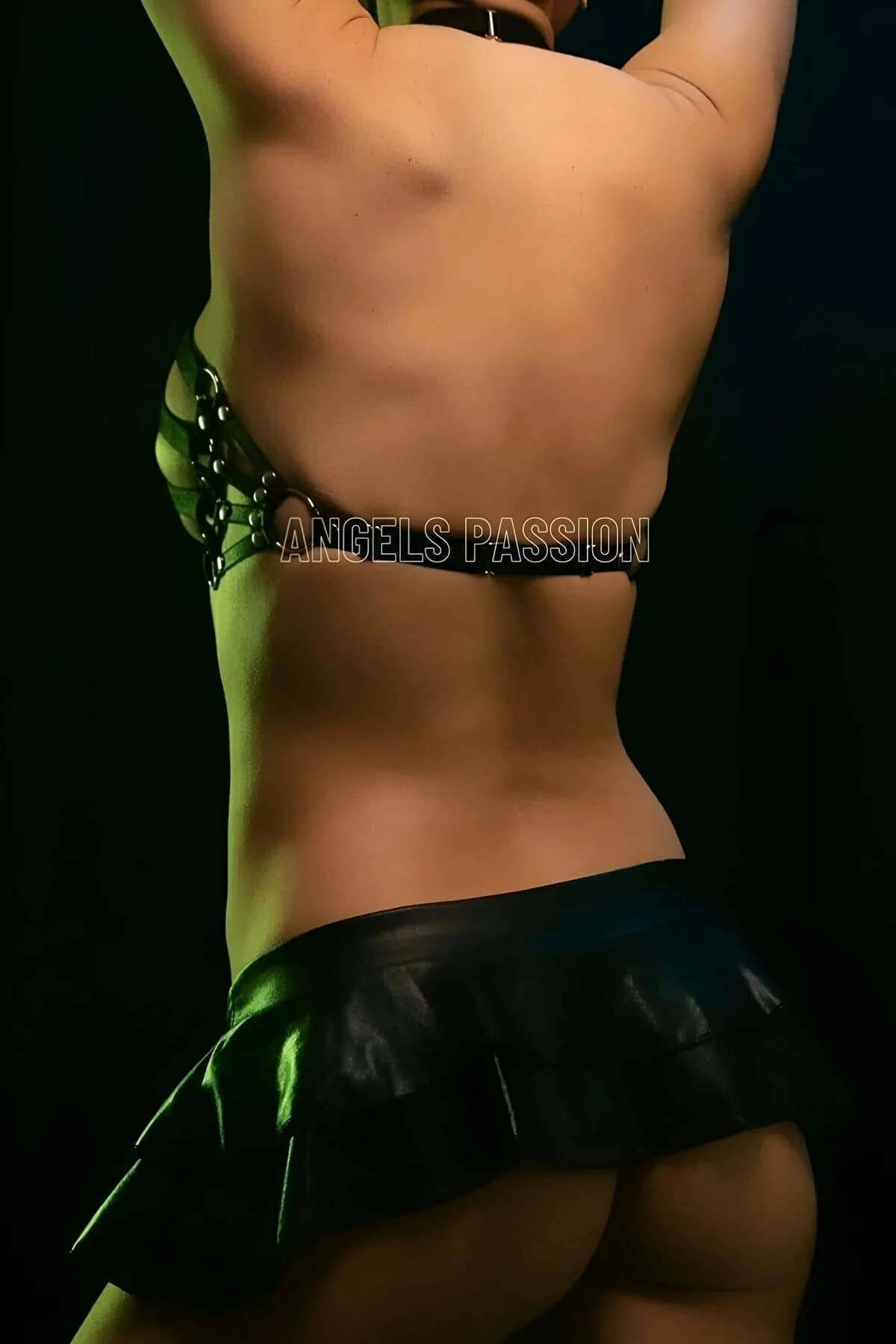 Black strappy chest harness worn over bare skin showing full fan strap configuration from front
