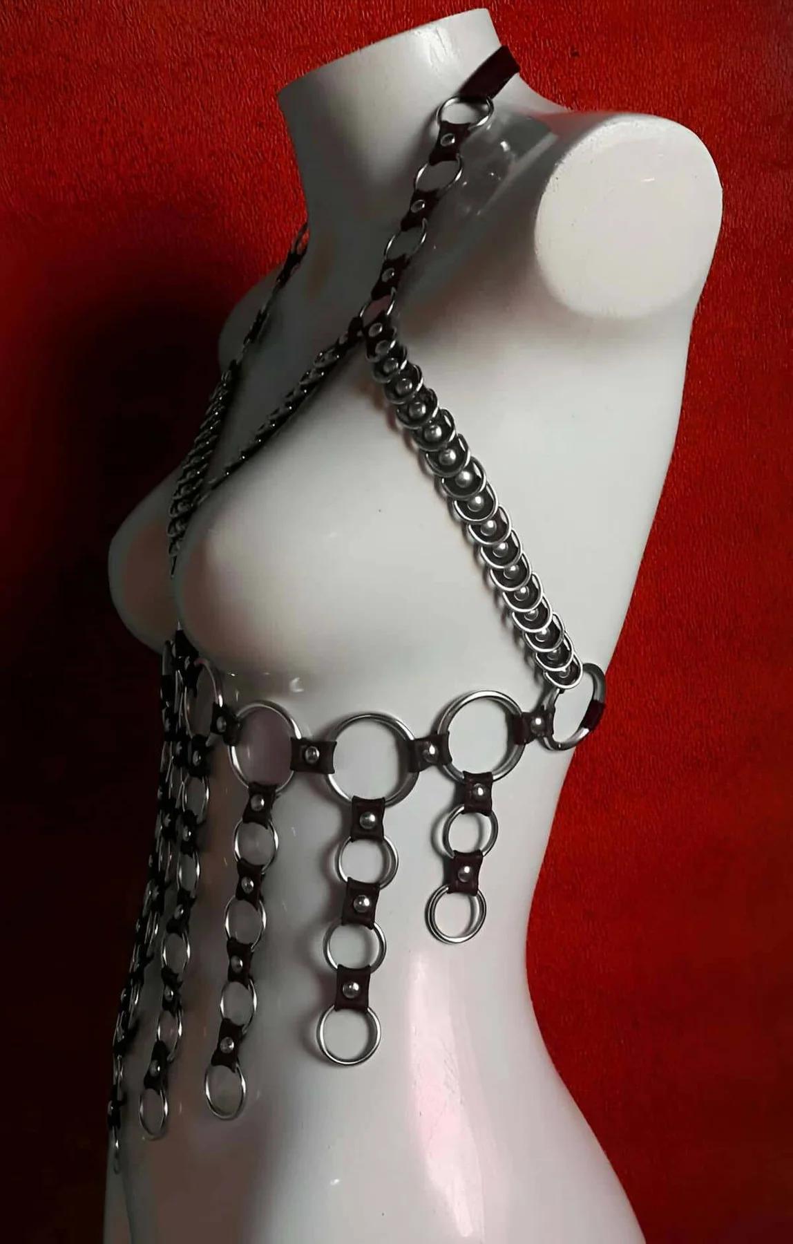 Full body harness with silver O-ring hardware styled over black outfit for festival look