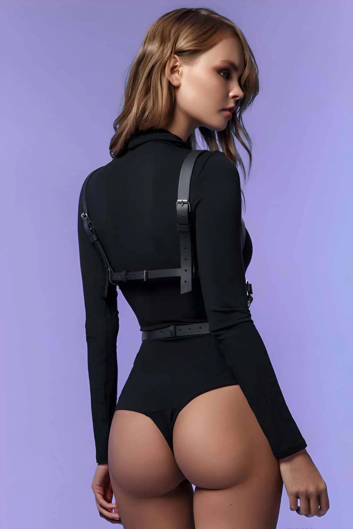 front view of black PU strap chest harness showing silver O-ring center detail and riveted junctions