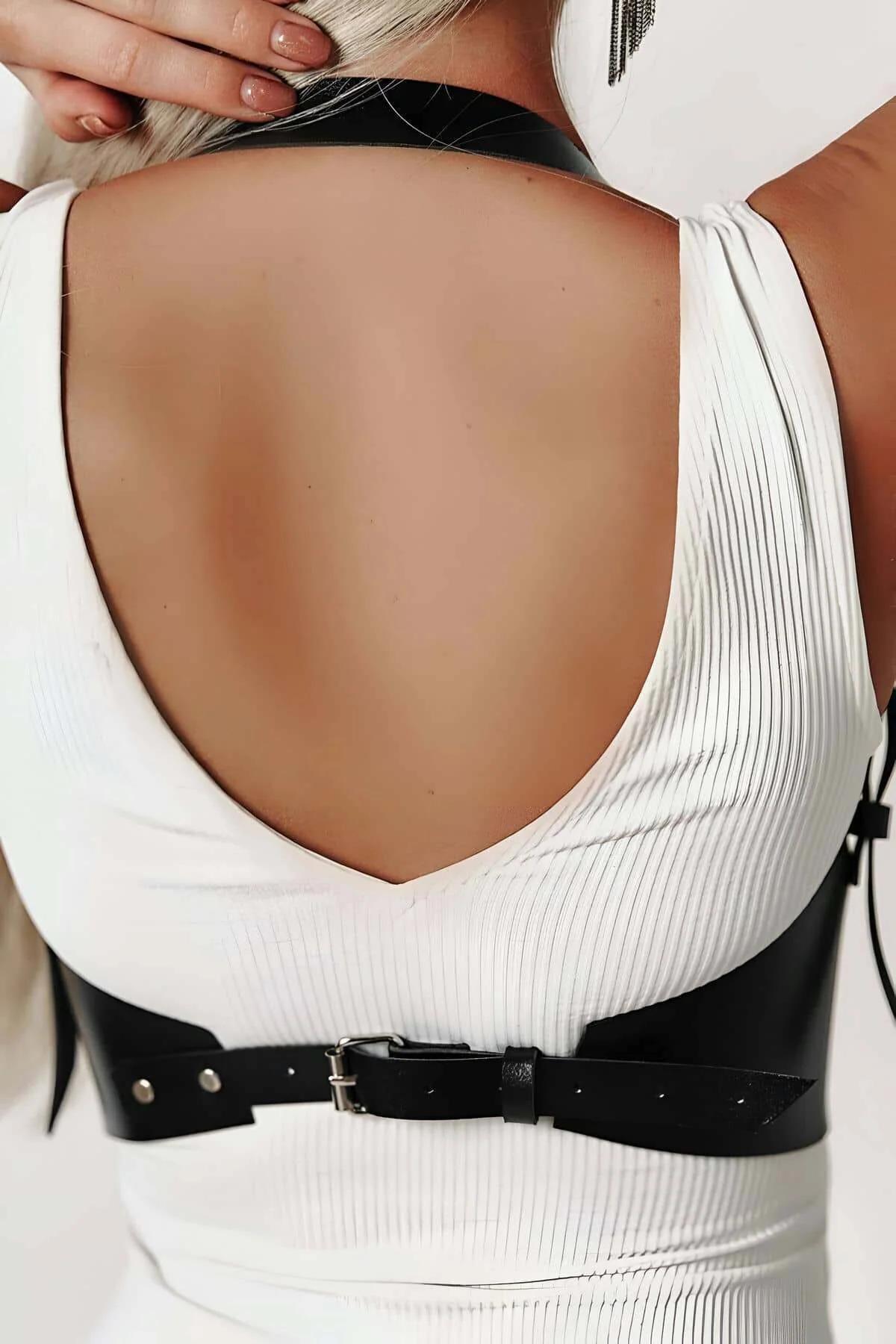 Sculpted black faux leather waist cinch corset showing adjustable back strap closure