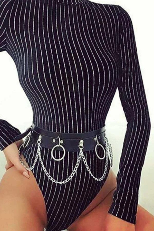 black faux leather waist harness belt with three silver O-rings and draped chain swags worn over striped bodysuit