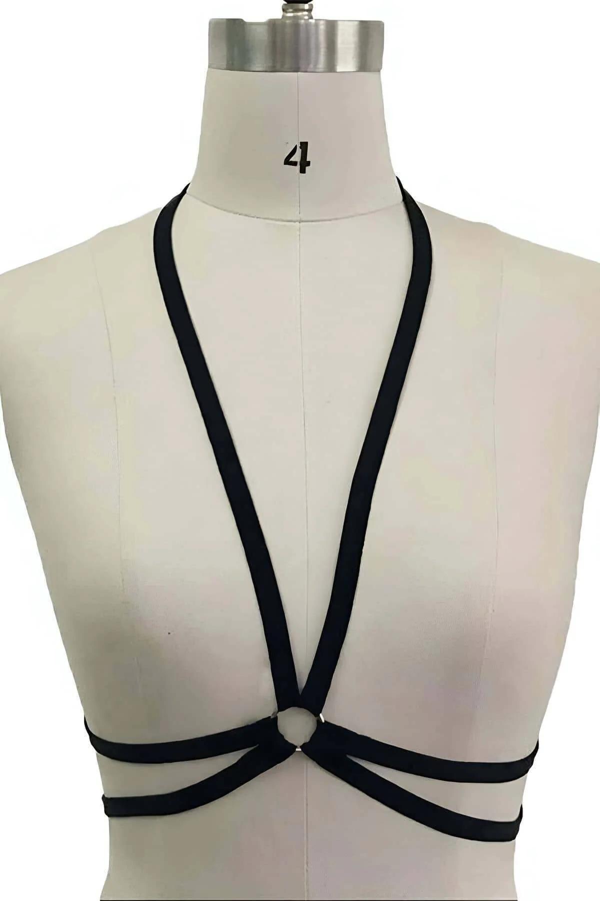 close-up of silver O-ring center on black multi-strap elastic chest harness