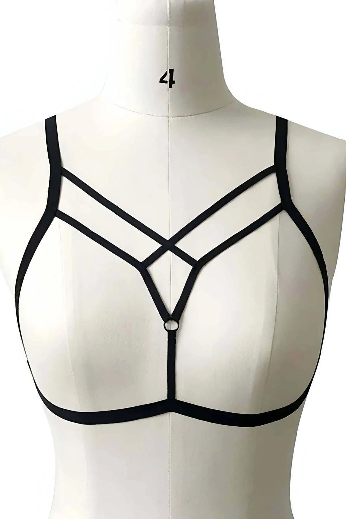 Close-up of silver-tone O-ring at center of black elastic V-neck harness straps crossing at sternum