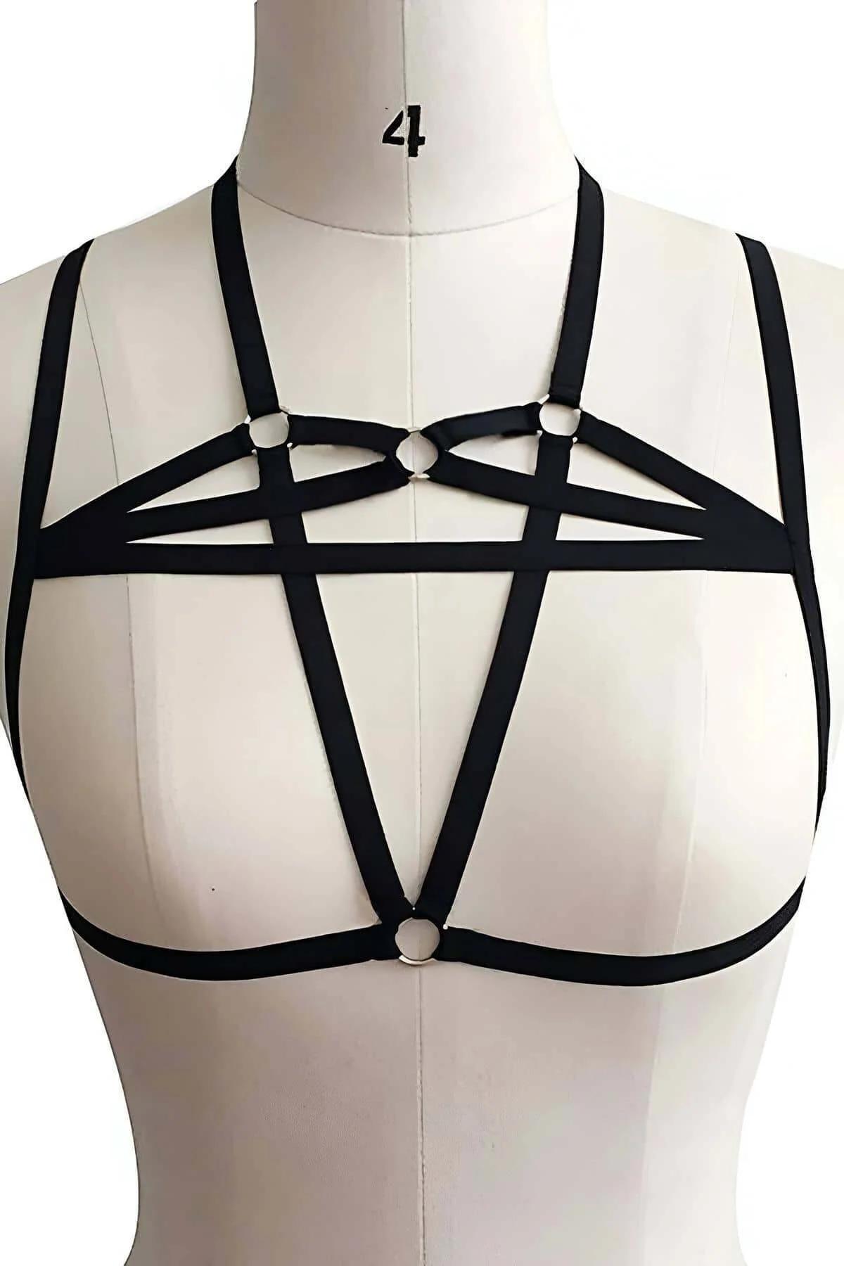 Close-up of silver O-ring strap junctions on black elastic starburst harness chest detail