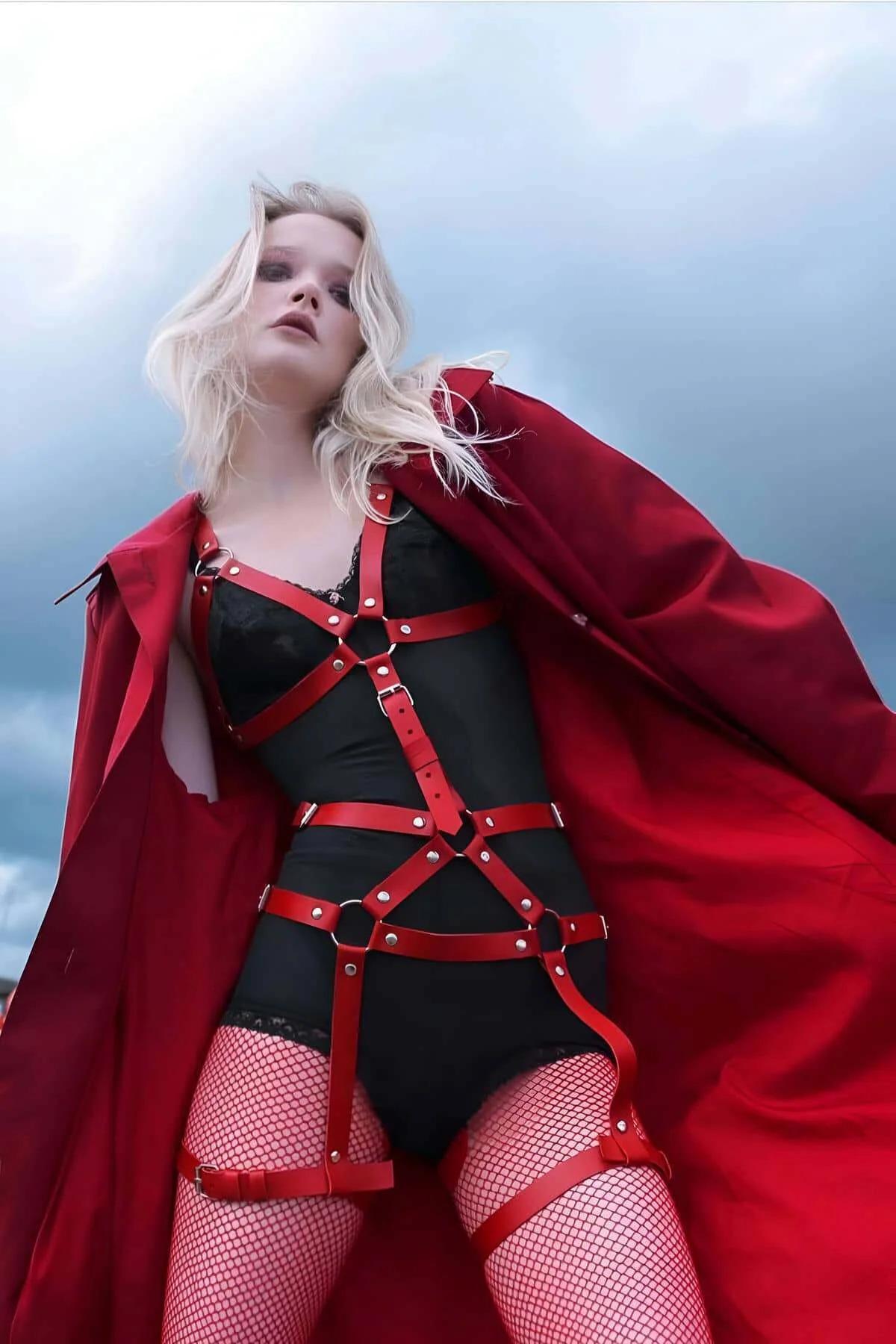 Red faux leather adjustable full body harness with silver O-rings and stud hardware on chest torso and thighs