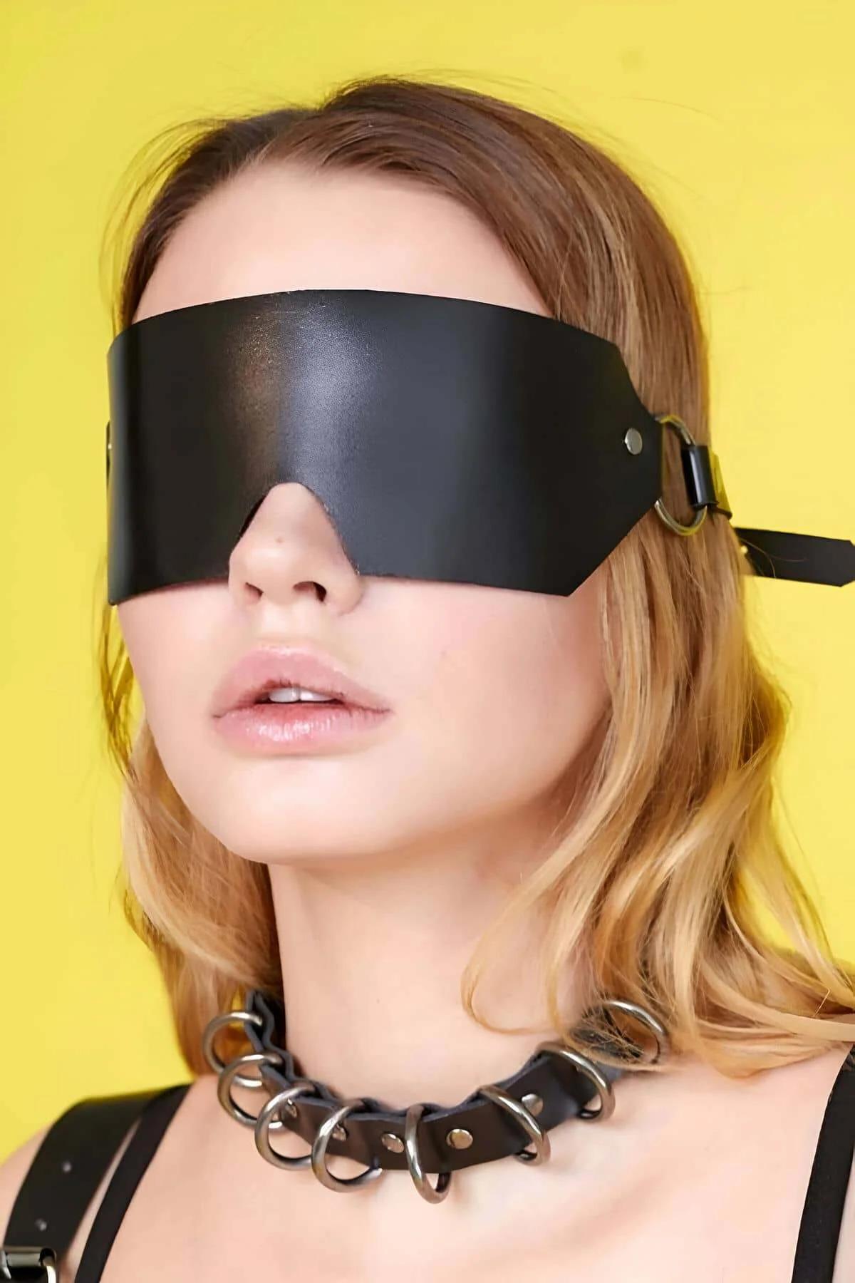 close-up of silver-tone metal rivets on black PU faux leather blindfold strap attachment point