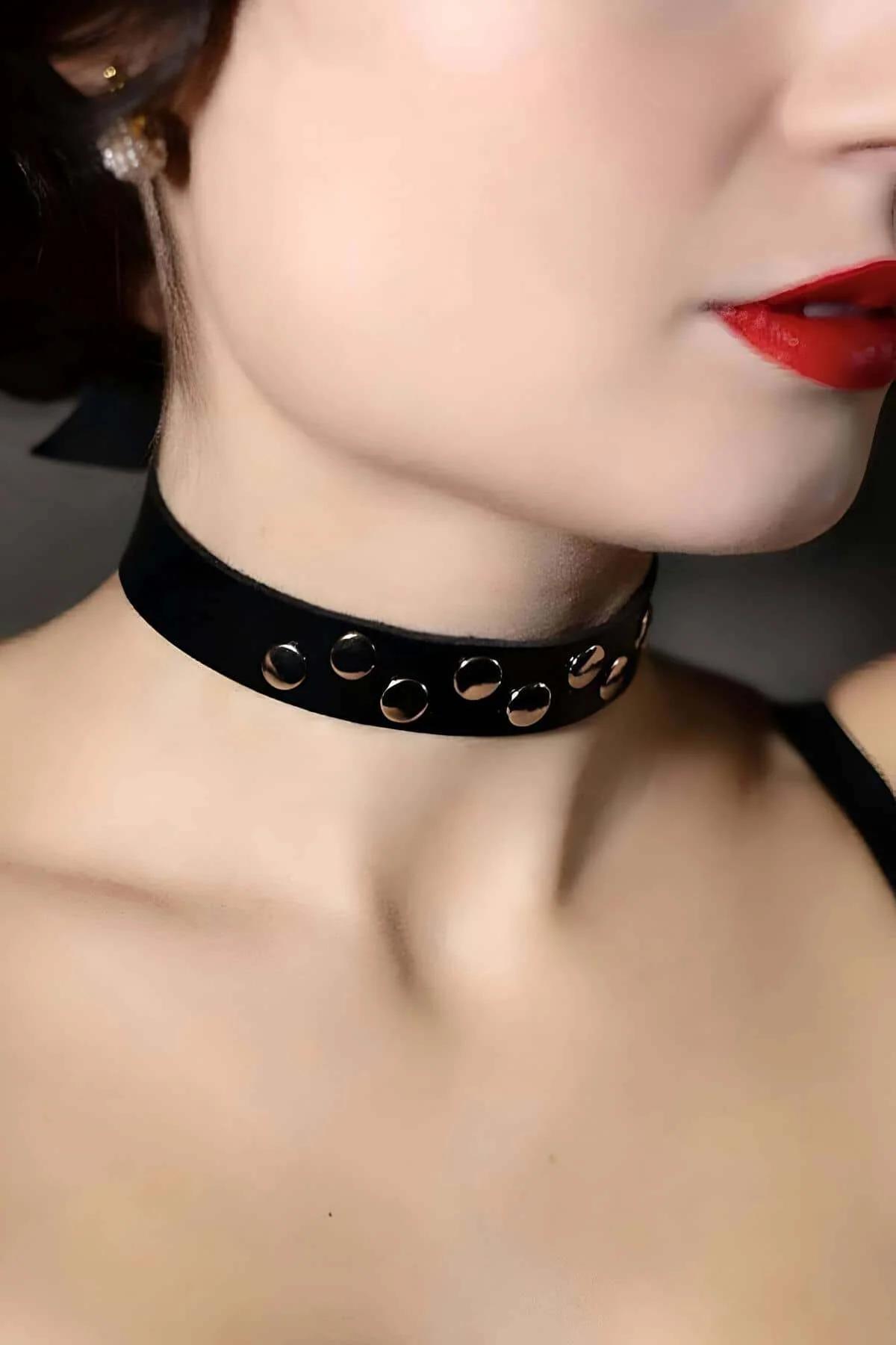 Black faux leather choker lying flat showing full strap length and buckle hardware detail