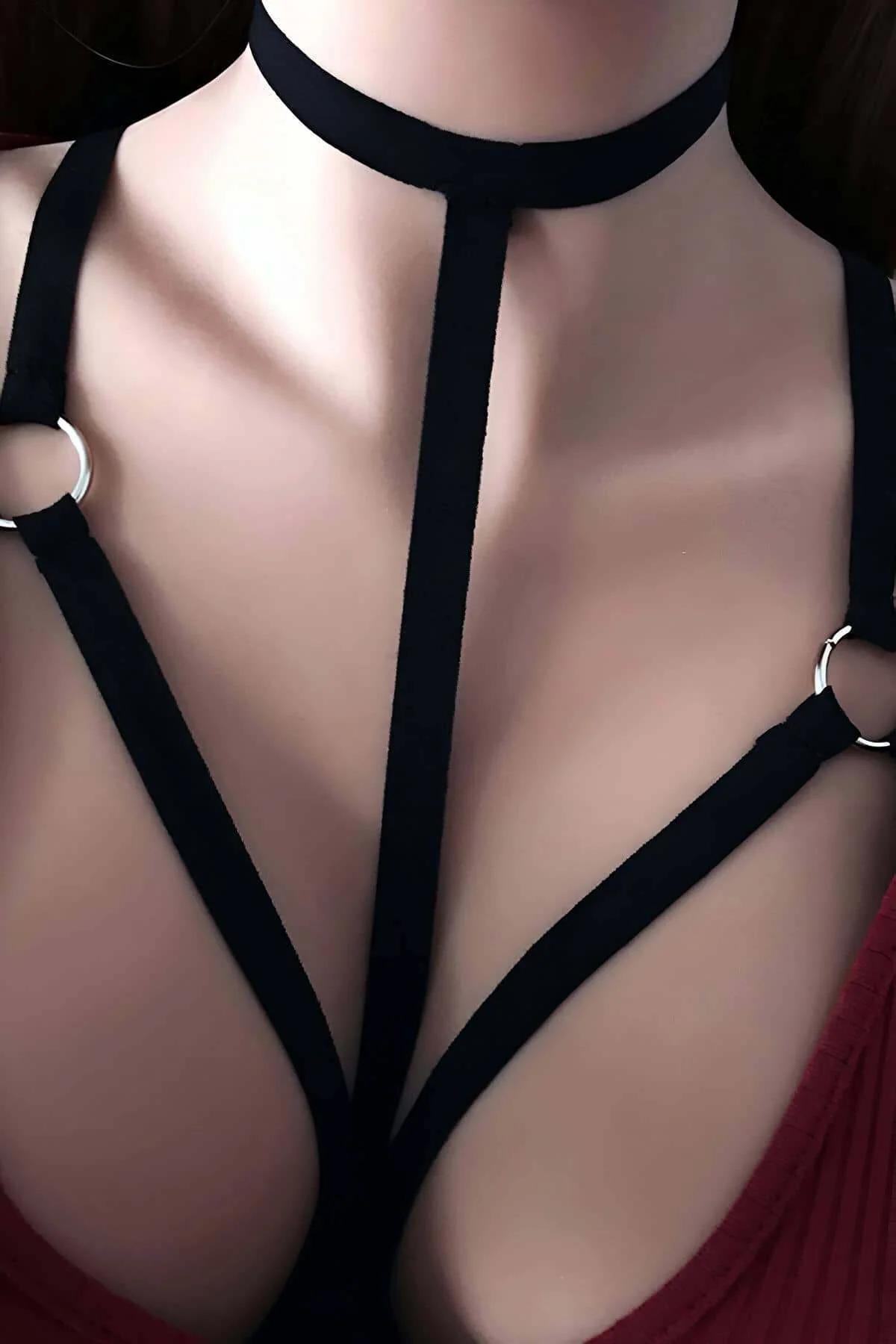 black choker neck harness worn over bare skin showing geometric strap silhouette