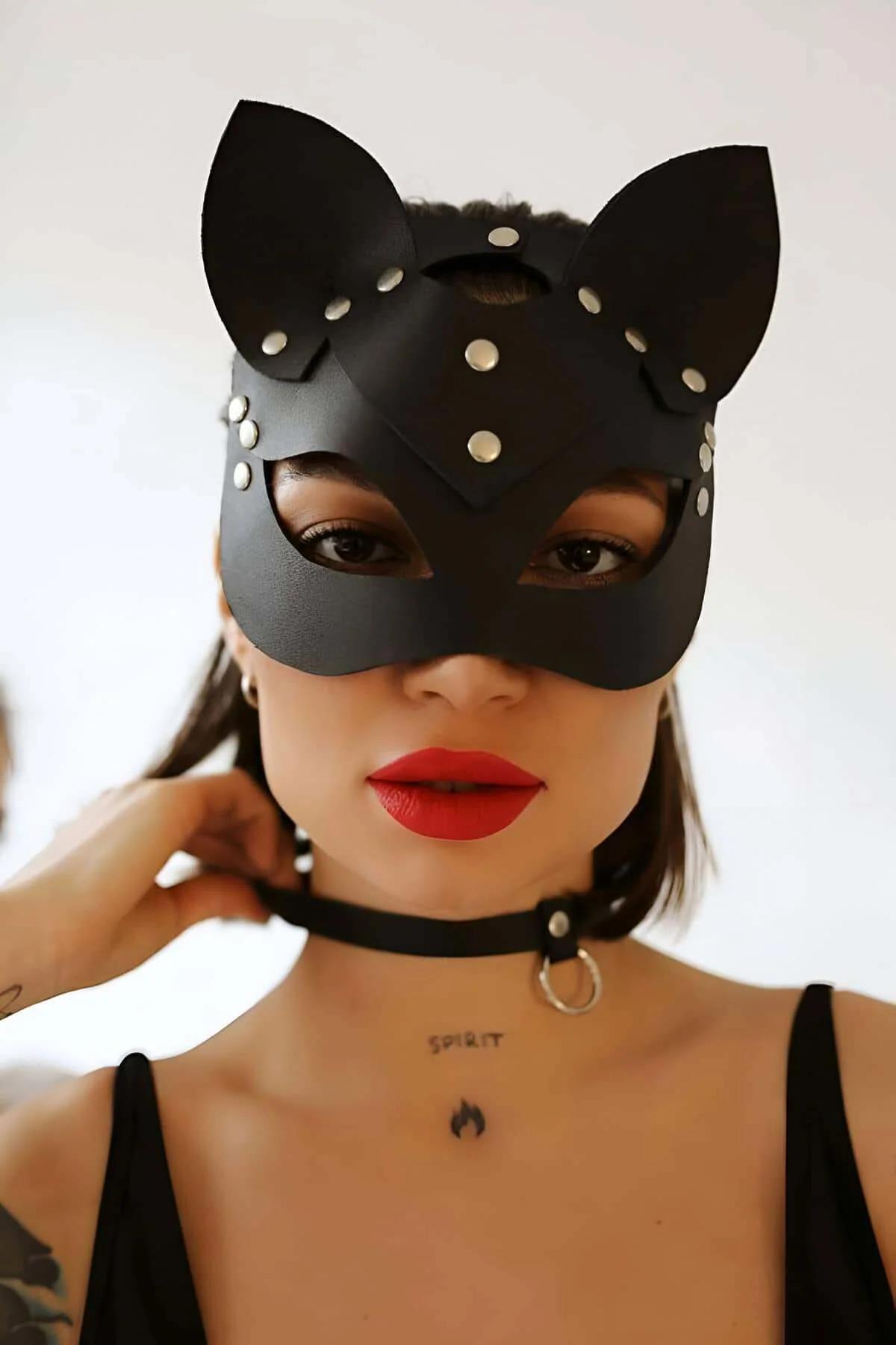 Close-up of silver stud detailing on black matte faux leather cat-ear mask panels