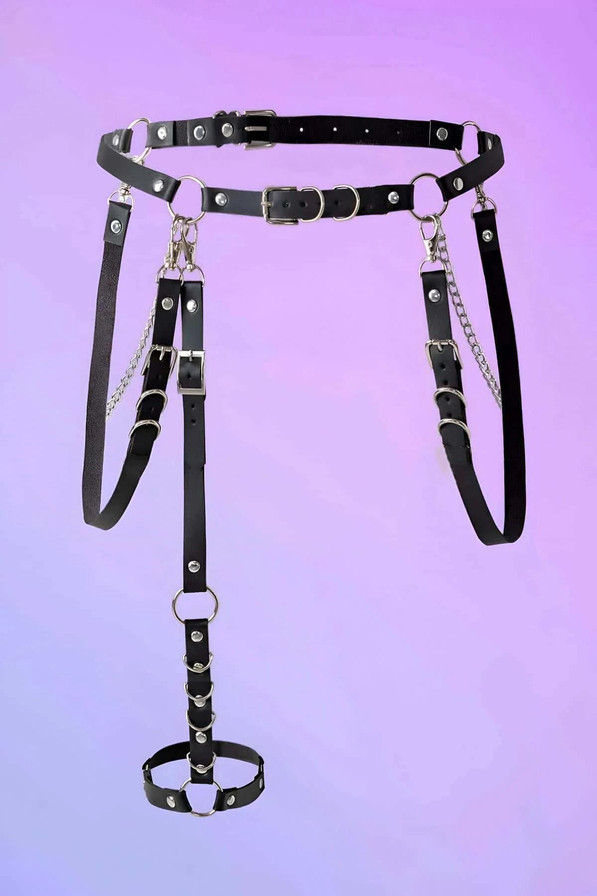 Close-up of silver O-ring and curb-link chain detail on black PU leather waist harness