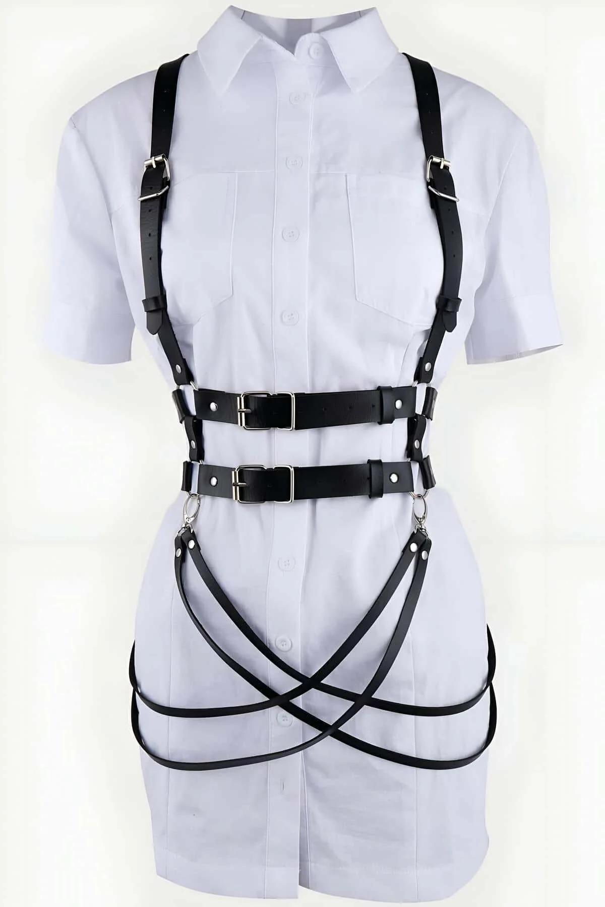 Black body harness shoulder strap adjustment detail with silver slide hardware on white background