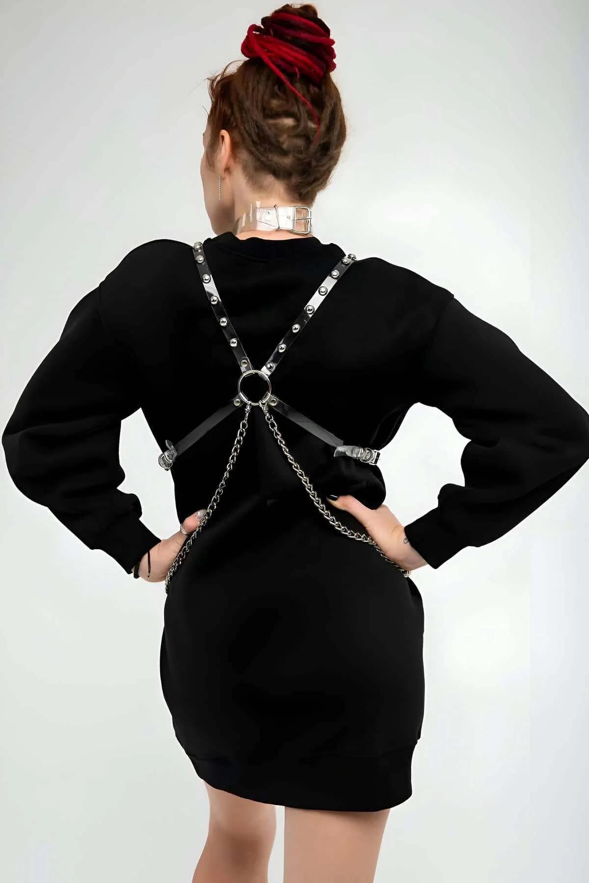 Silver O-ring and carabiner clasp detail on clear studded chest harness front view