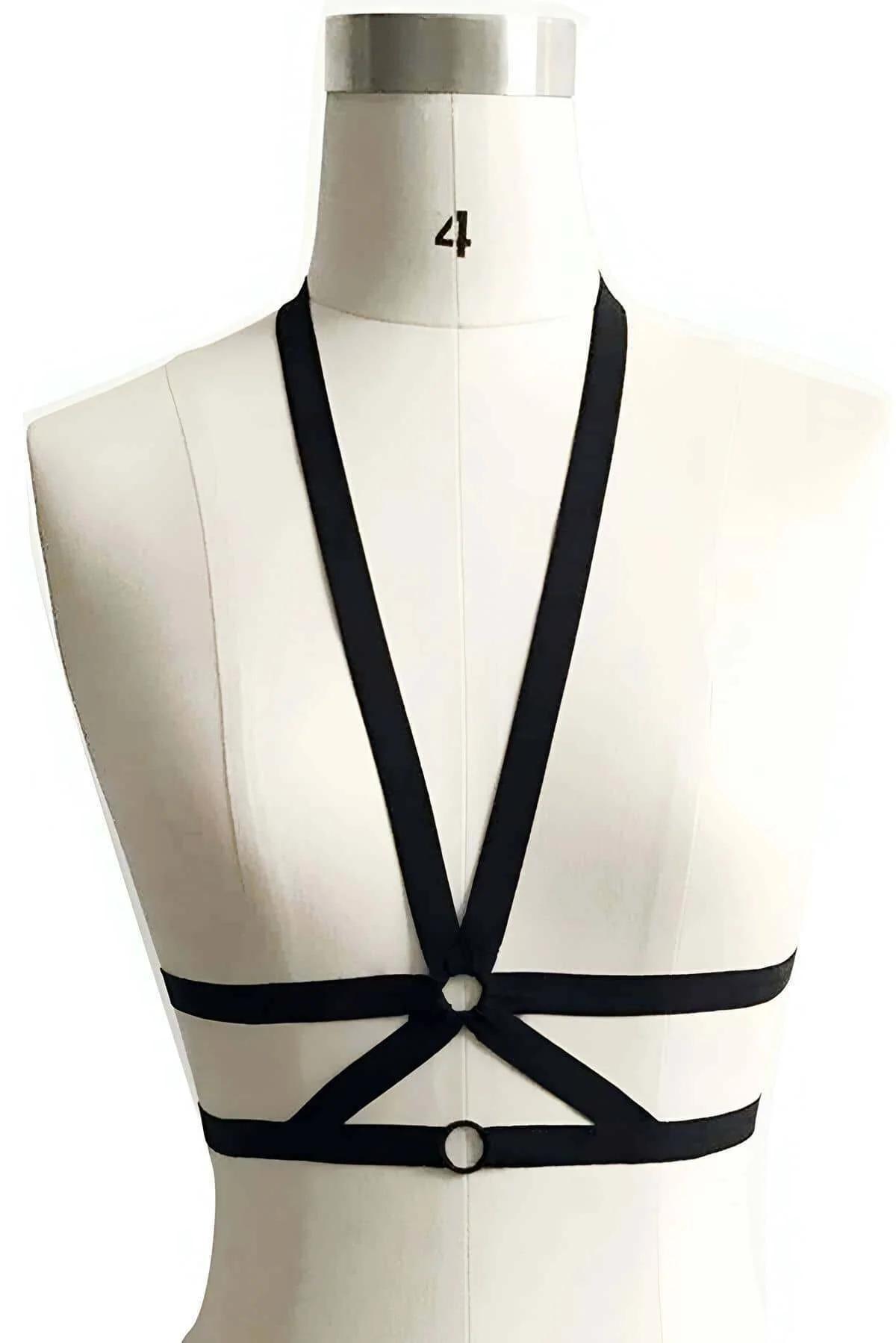 flat lay of black O-ring chest harness showing adjustable strap layout and hardware