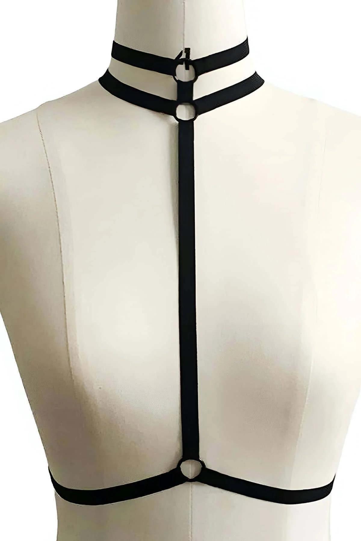 Adjustable waist band of black faux leather body harness with metal buckle closure, close-up
