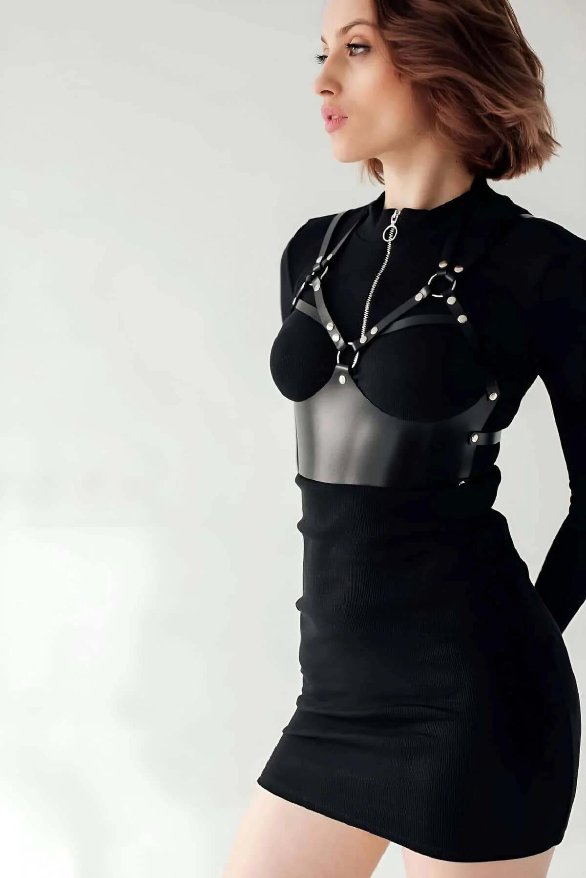 Black bustier harness back closure and adjustable strap detail on female model