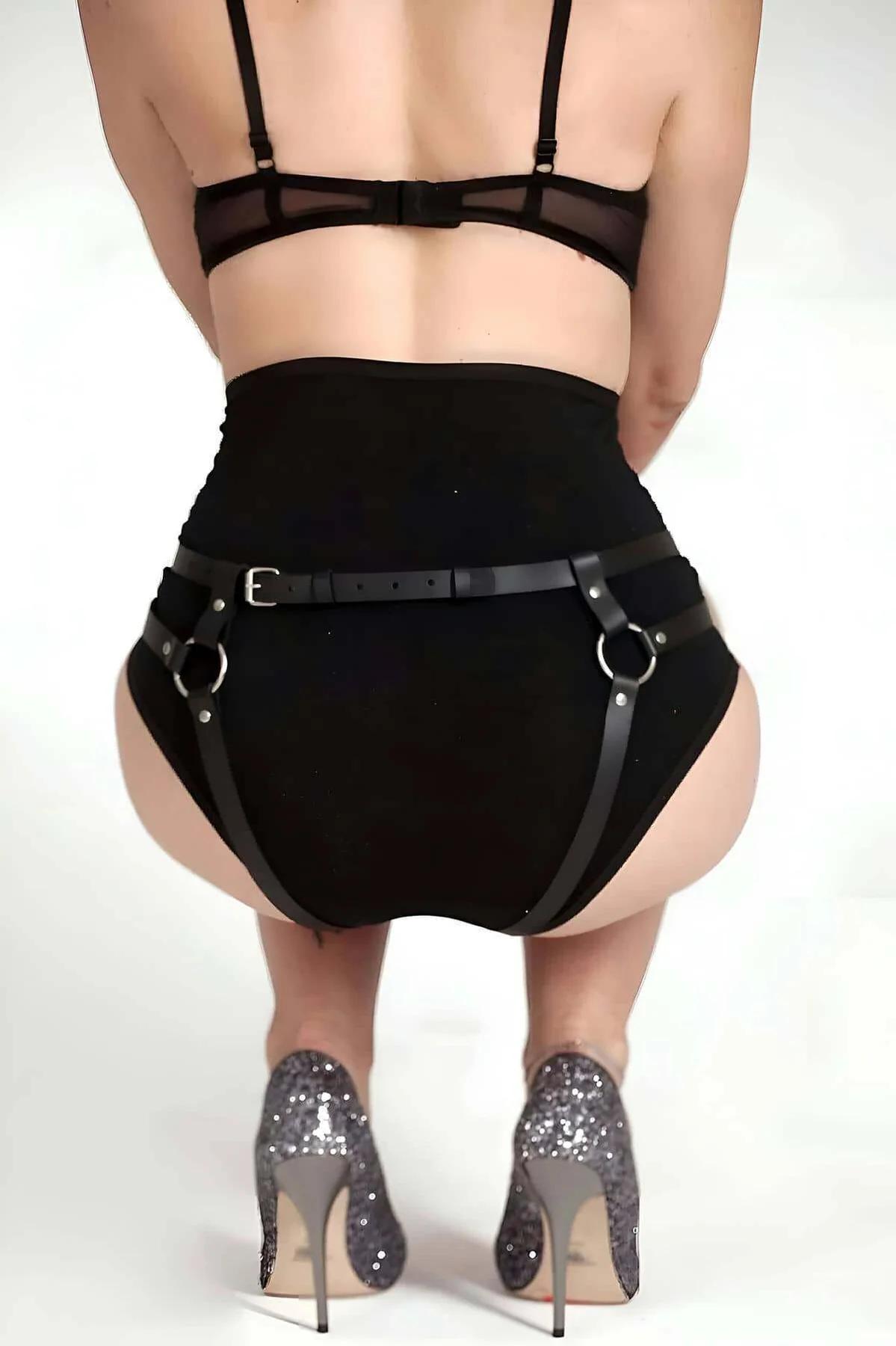 Close-up of silver O-ring hardware connecting faux leather straps on black high-waisted panty