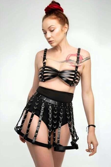 black faux leather multi-band chest harness with silver D-ring center-front close-up