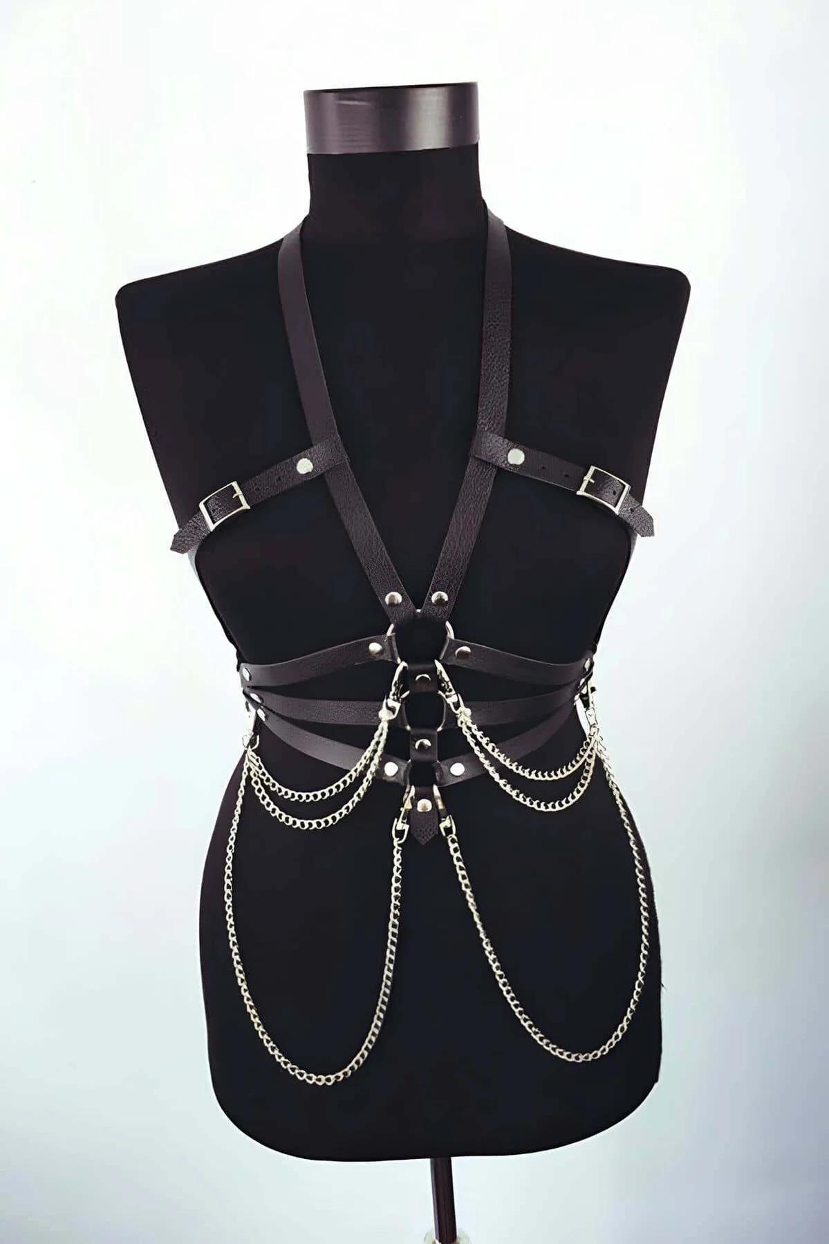 black faux leather body harness with four cascading silver chains draped from waist O-ring and adjustable shoulder buckle str