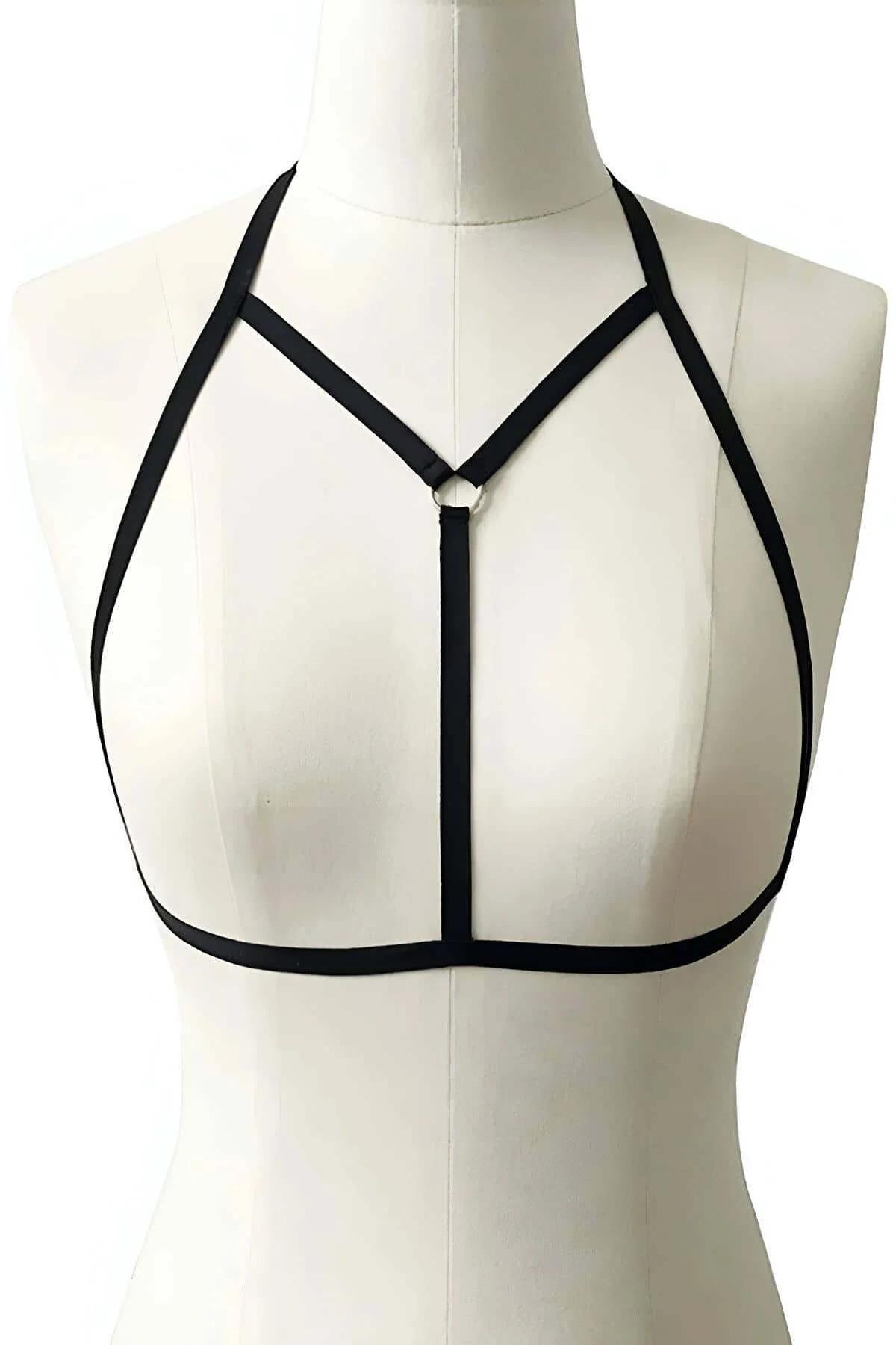 black cage bra styled over bare torso showing full strap cage silhouette from above