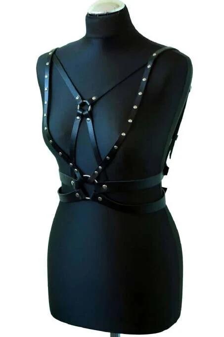 close-up of silver dome rivets on black PU faux leather harness straps